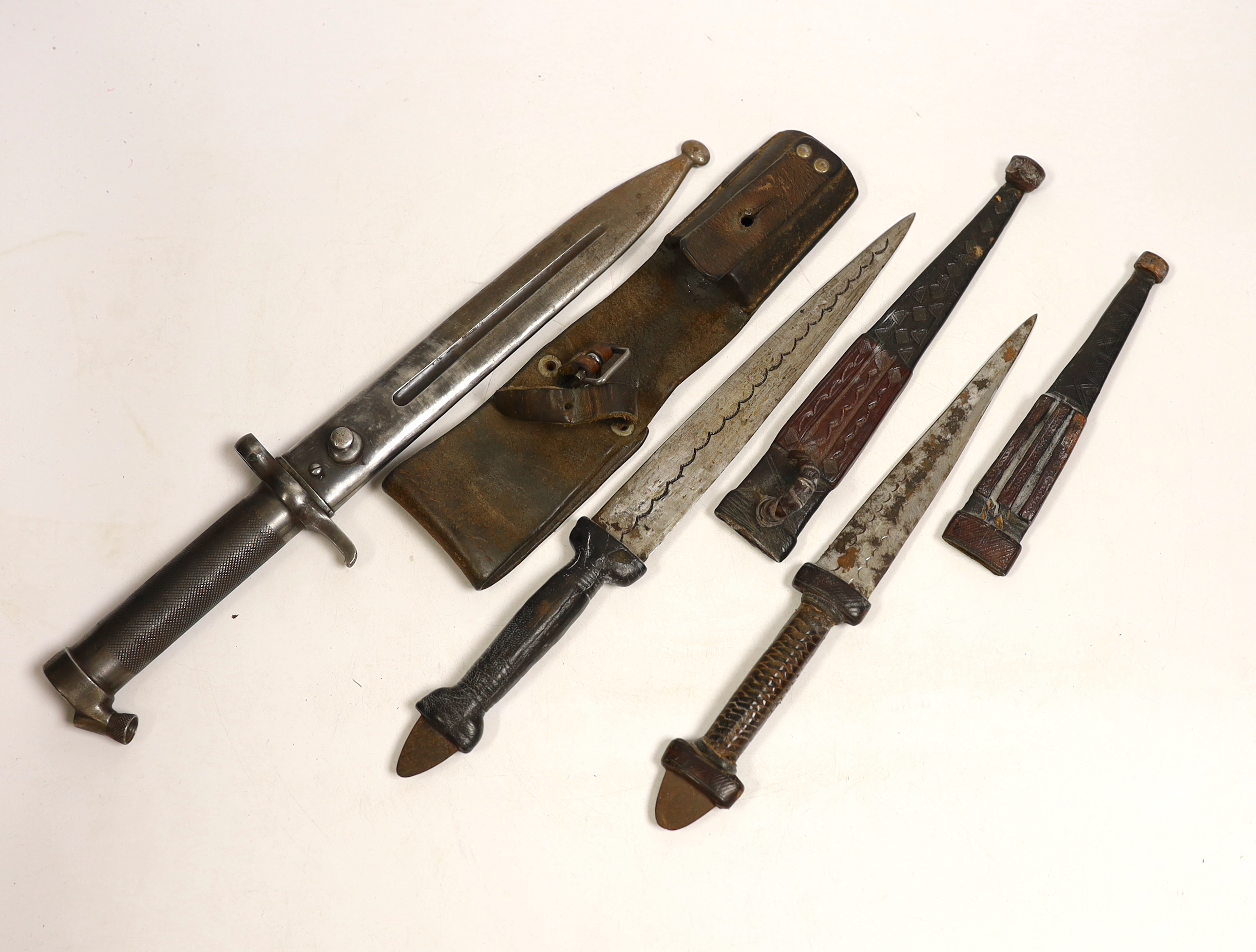 A Swedish Mauser bayonet and two North African daggers